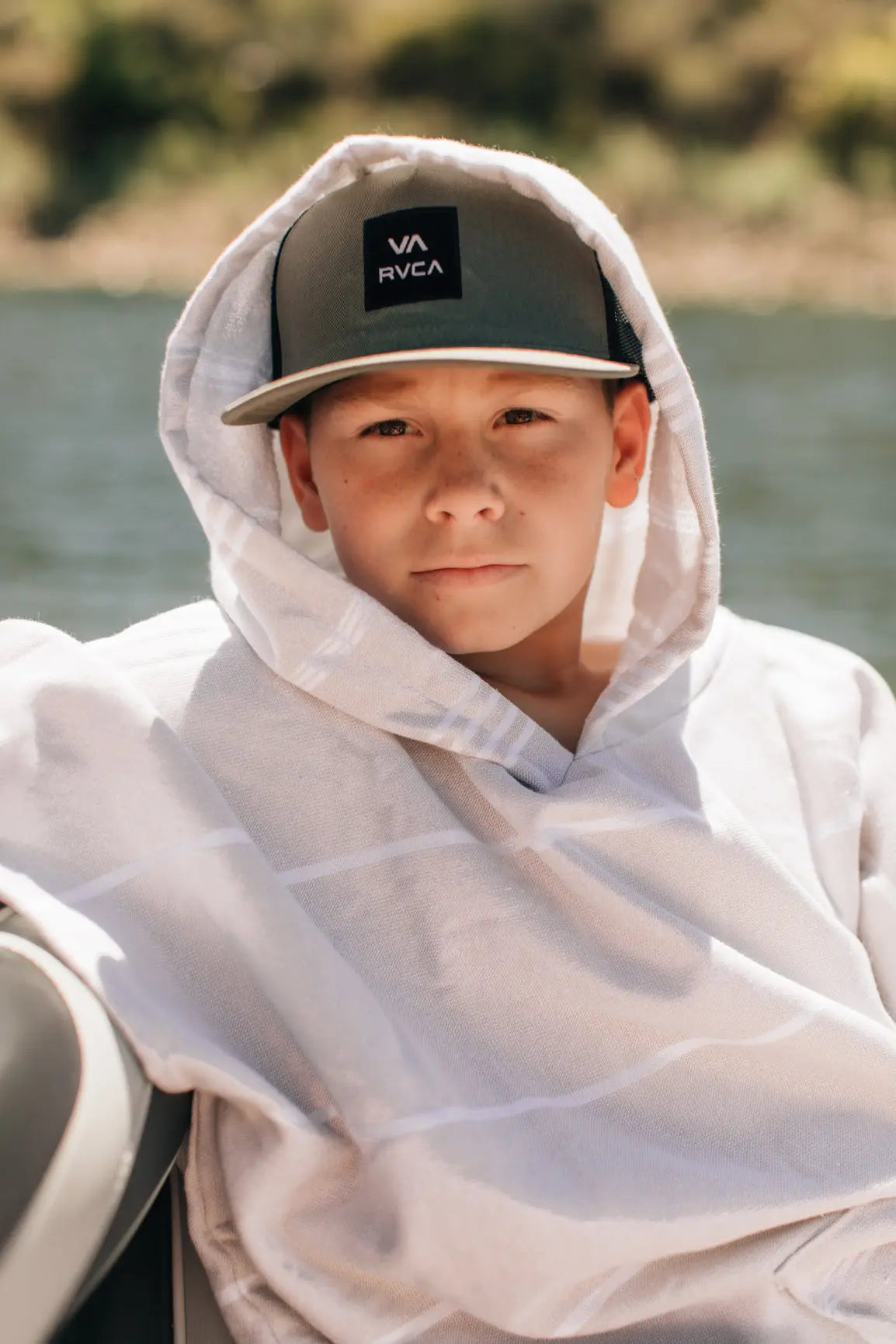 young boy on surf boat in hooded towel changing poncho turkish towel sand free 
