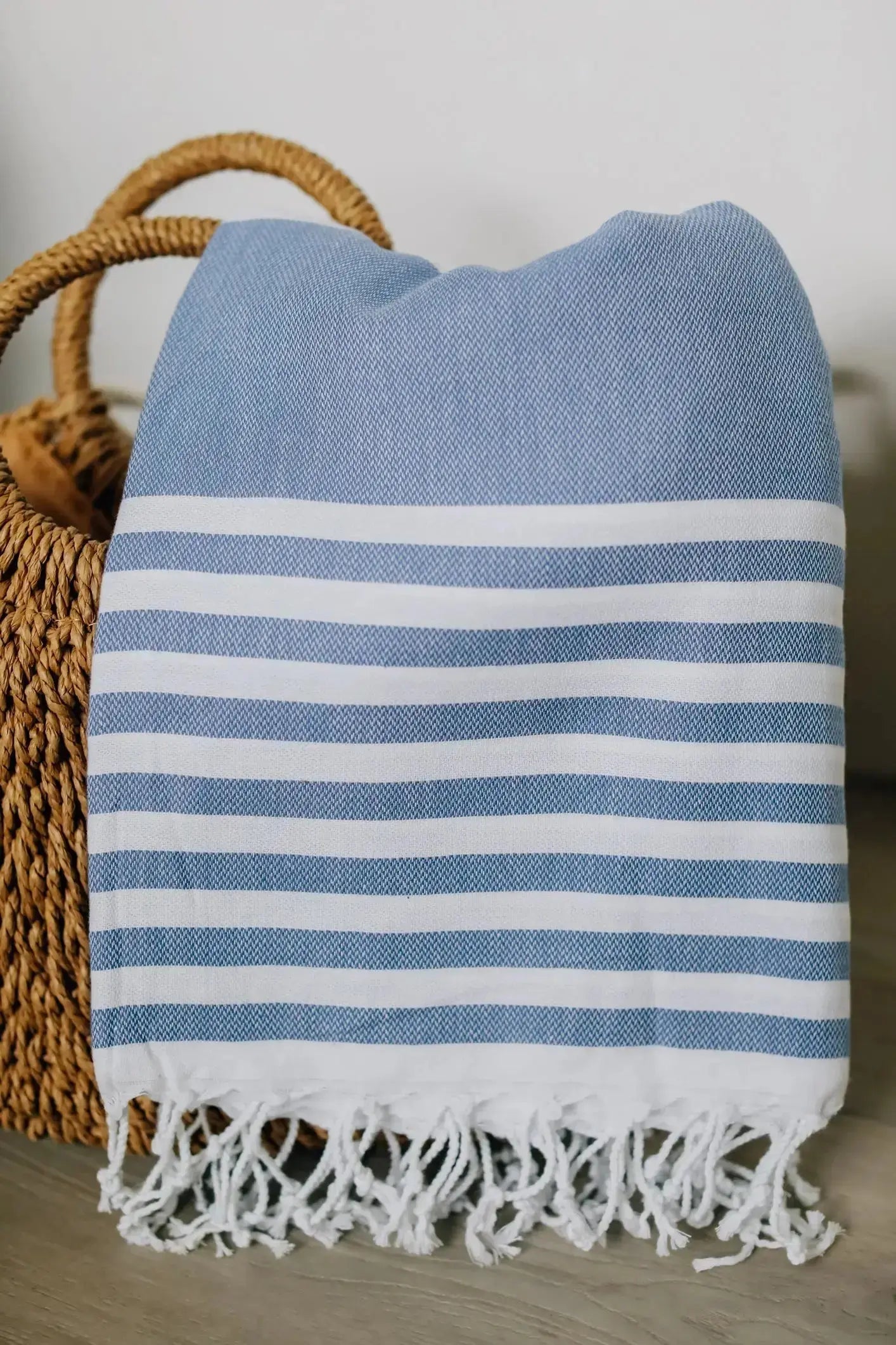 cabana print turkish towel . blue and white stripe with  tassels in beach bag 