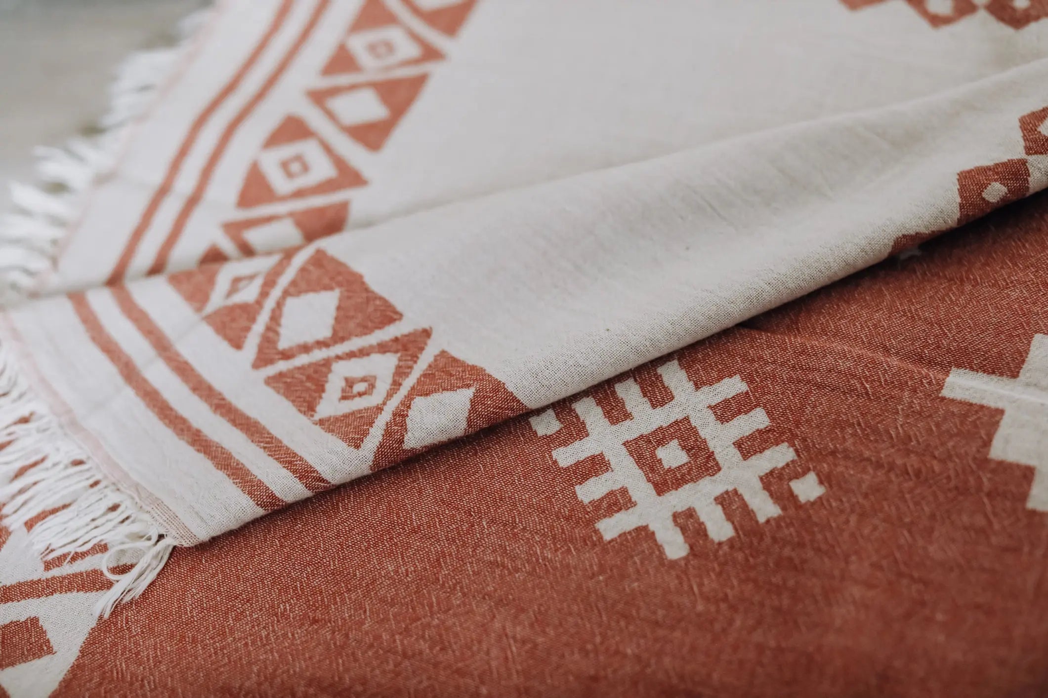 close up terracotta orange turkish towel with tribal and diamond print 