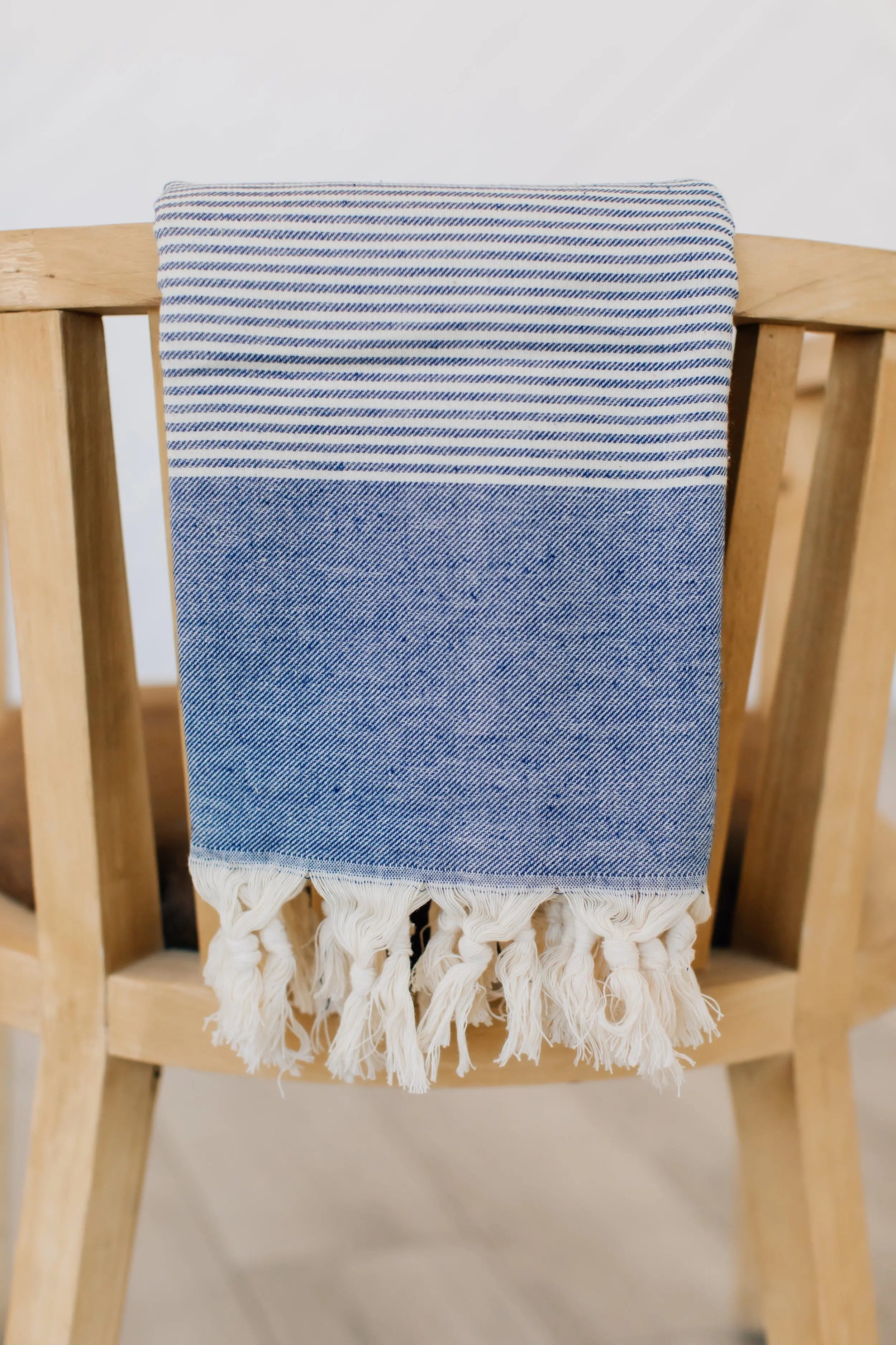 light blue soft turkish towel with stripes and hand tied tassels